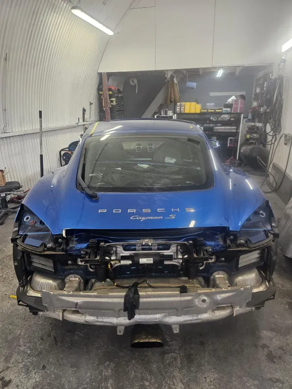 Blue Porsche Cayman undergoing accident repair